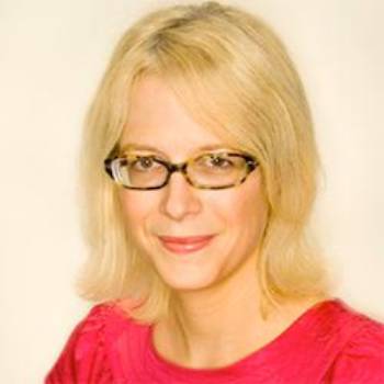 Headshot of Karin Fischer Wearing a Pink Top Against a Light Background