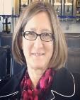 Peggy Christoff headshot, medium length hair and wearing glasses
