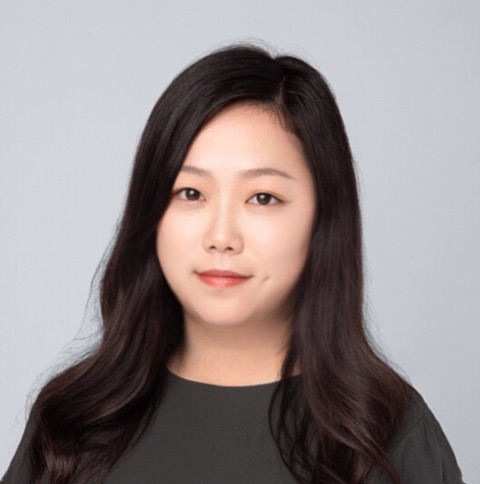 headshot of Yi Wang smiling in grey shirt