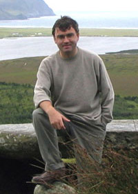 Maurice Kernan standing in front of grass and a body of water