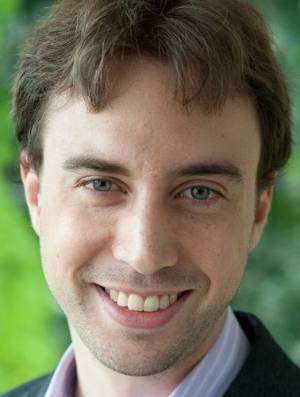 Headshot of Braden Brinkman against a green background
