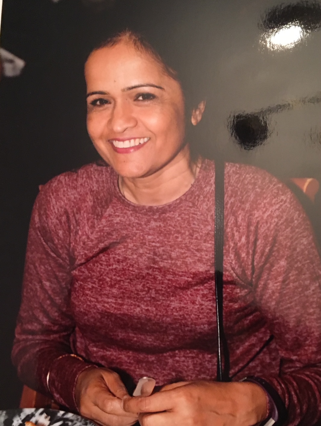 Headshot of Elsie Persaud standing in front of a black background