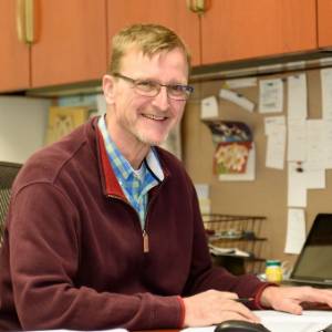 Headshot of Lonnie Wollmuth sitting at office desk