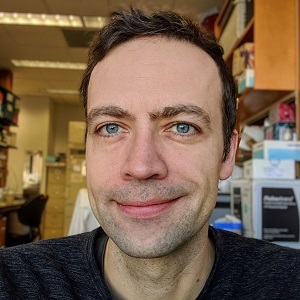 Headshot of Markus Riessland with lab benches in background