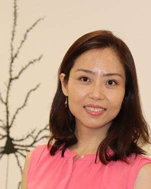 Headshot of Qiaojie Xiong with painting of a neuron in the background