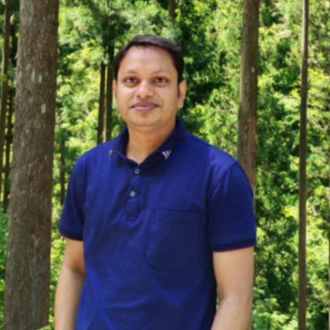 Sajib Podder standing in front of trees