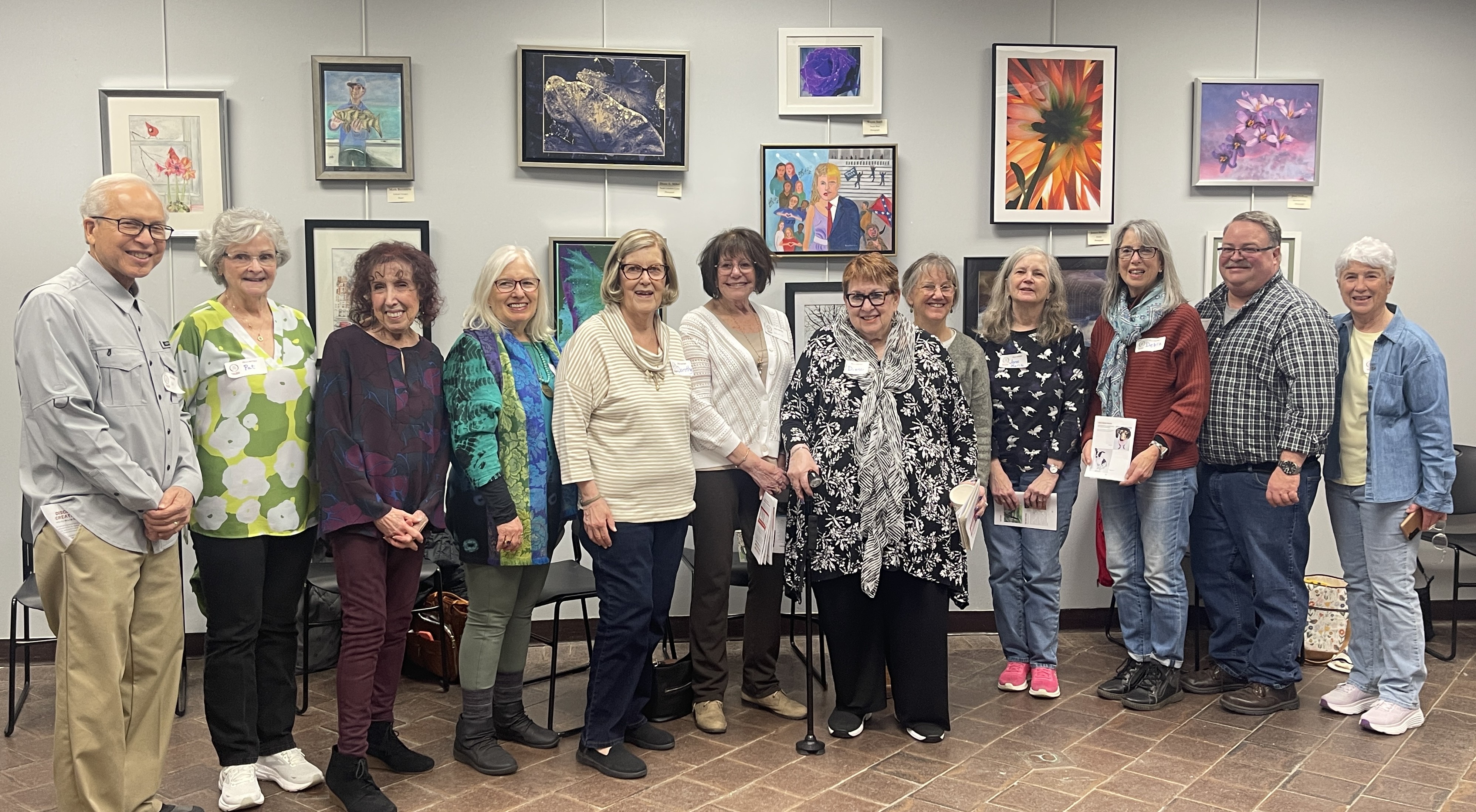 Art showcase with artists standing in front