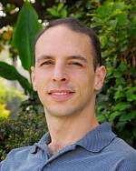 Headshot of Peter DeScioli in front of trees.