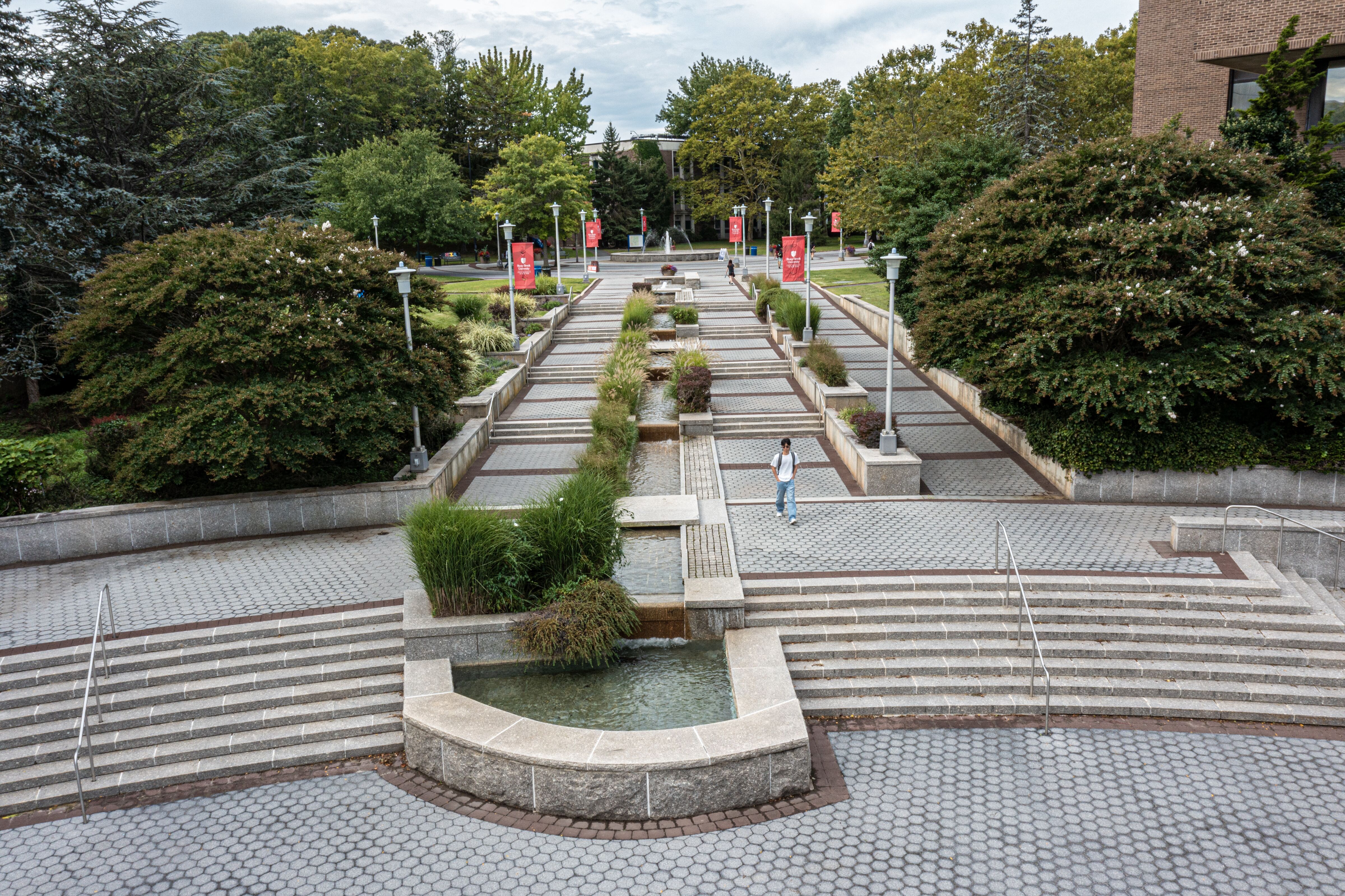 An ariel view of gray concrete steps with a water fountain.