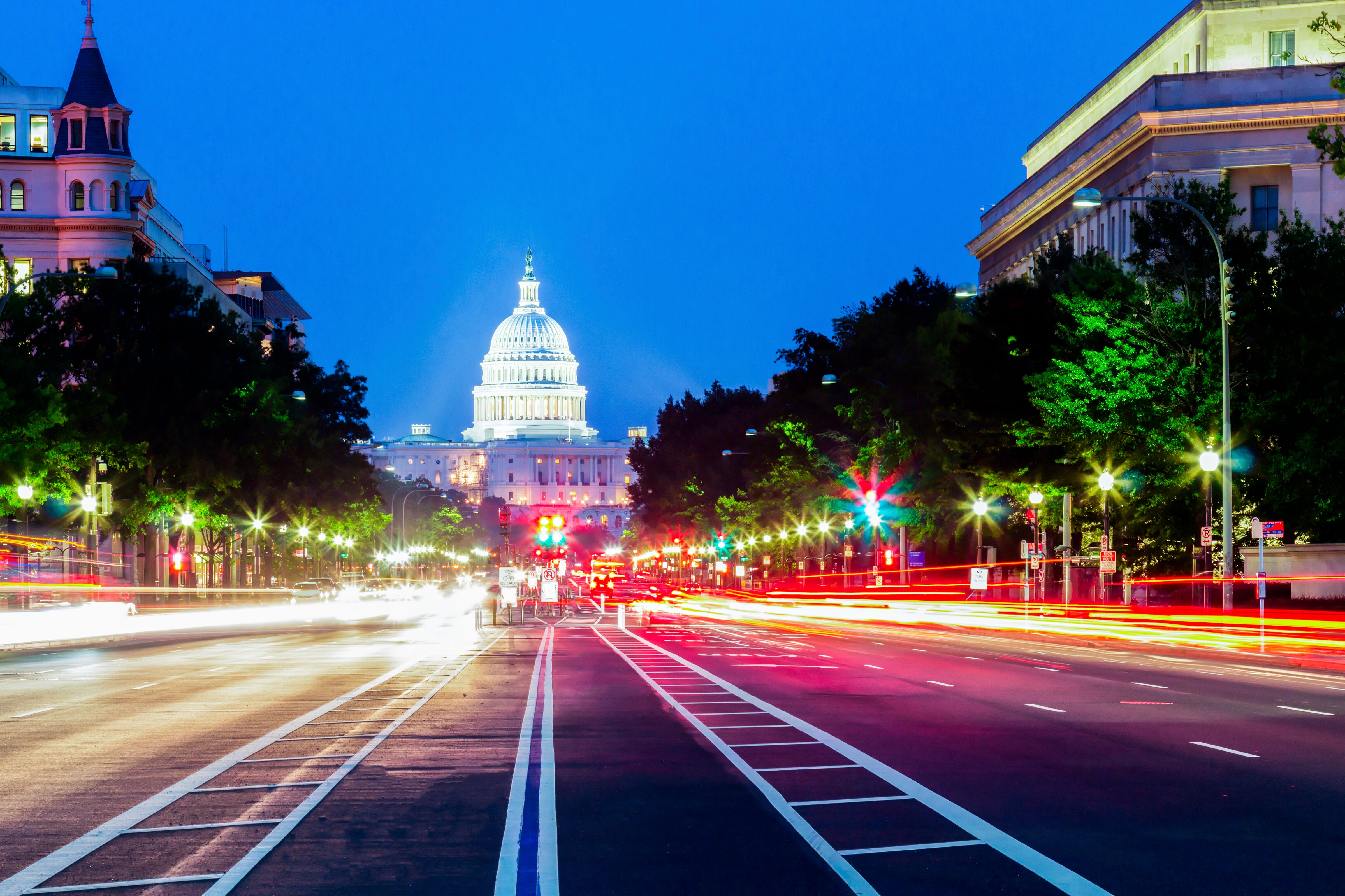Traffic in front of the capitol building at night