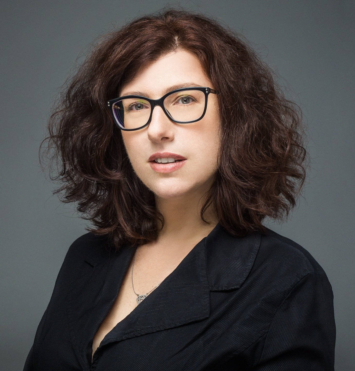 Headshot of Pazit Ben-Nun Bloom in front of a grey background. 