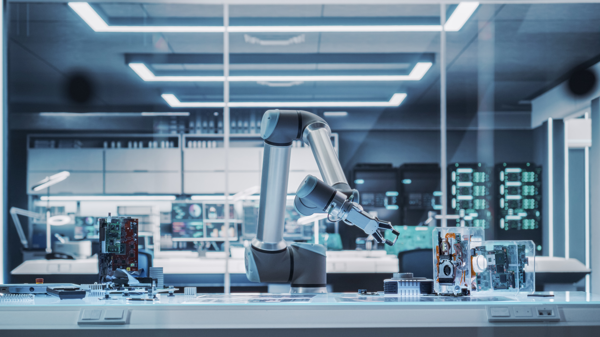 An automated robotic arm sits on a workbench inside a modern biotechnology testing laboratory