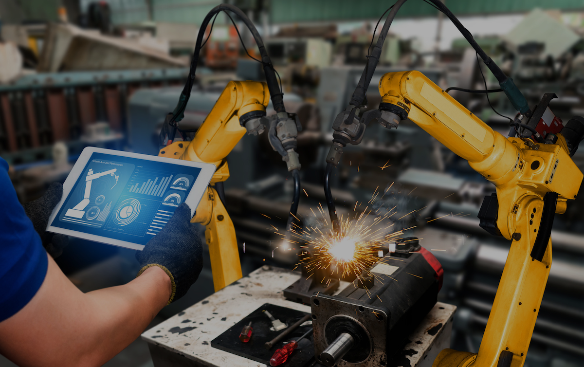 Two robotic devices being controlled by a person holding a tablet