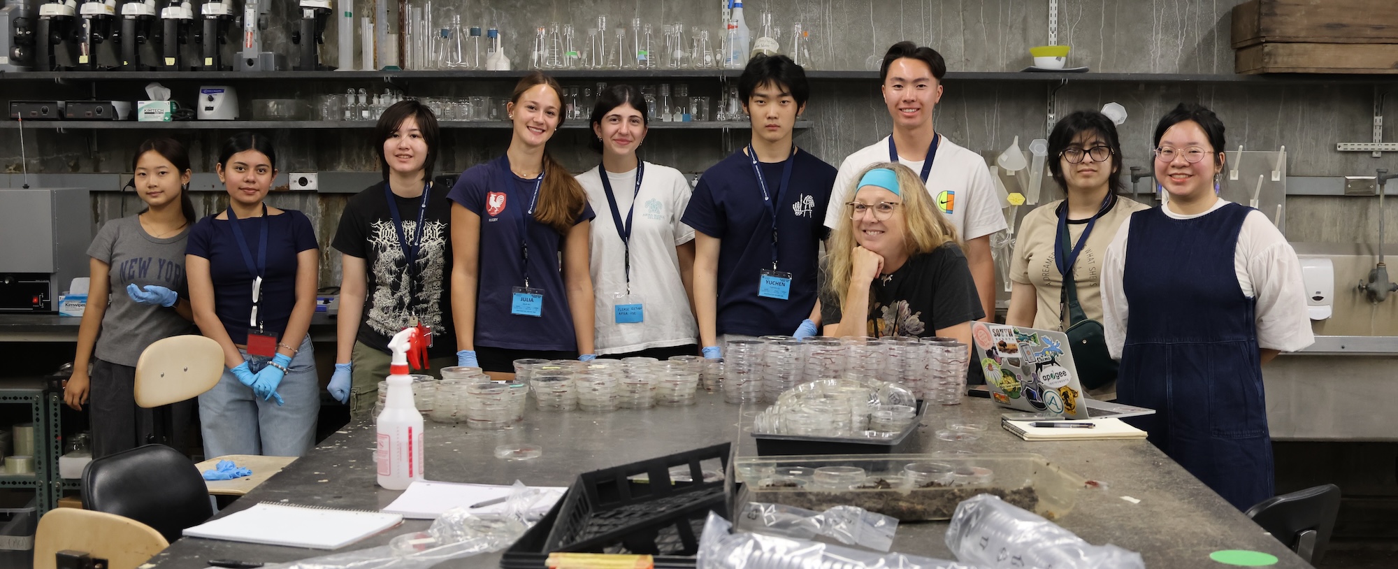 A group of PCS participants, their instructor and graduate student assistant in the worm lab at Stony Brook's greenhouse