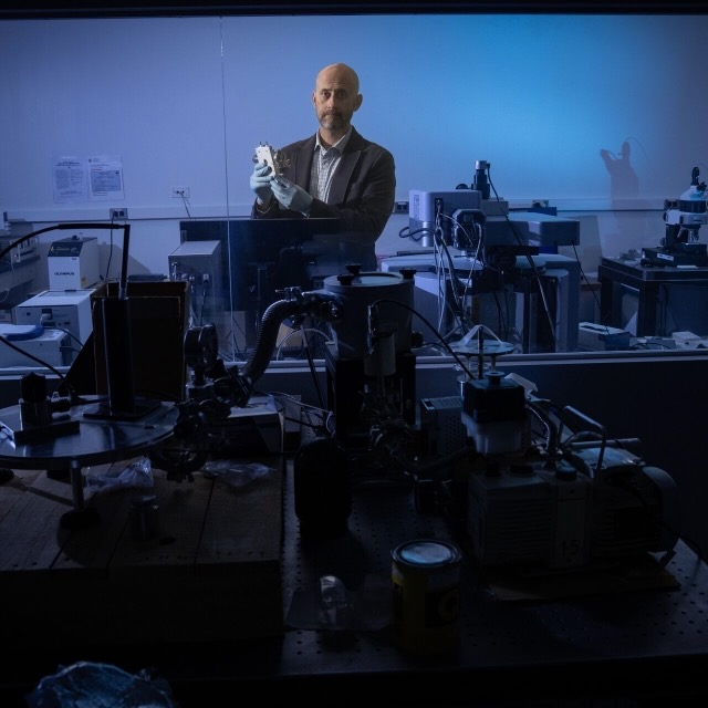 A faculty member in his research lab.