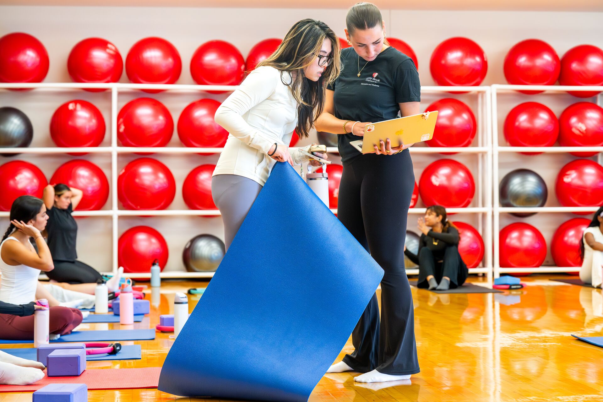 A fitness instructor teaching a student.