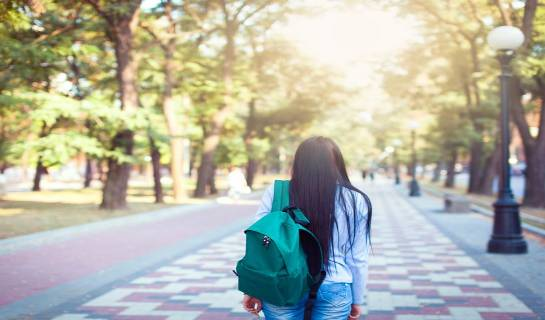 Student alone walking on campus
