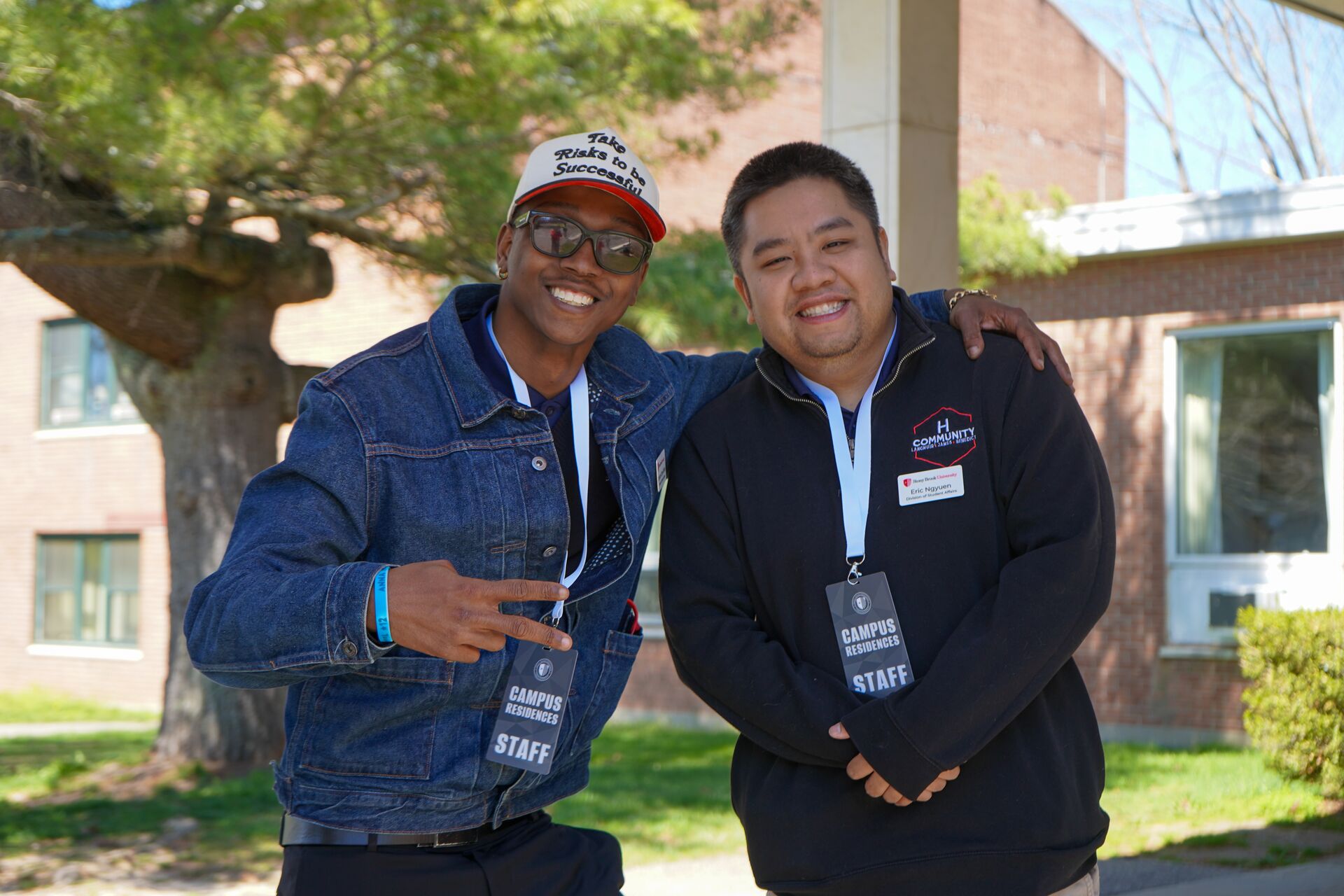 two staff members pose for photo