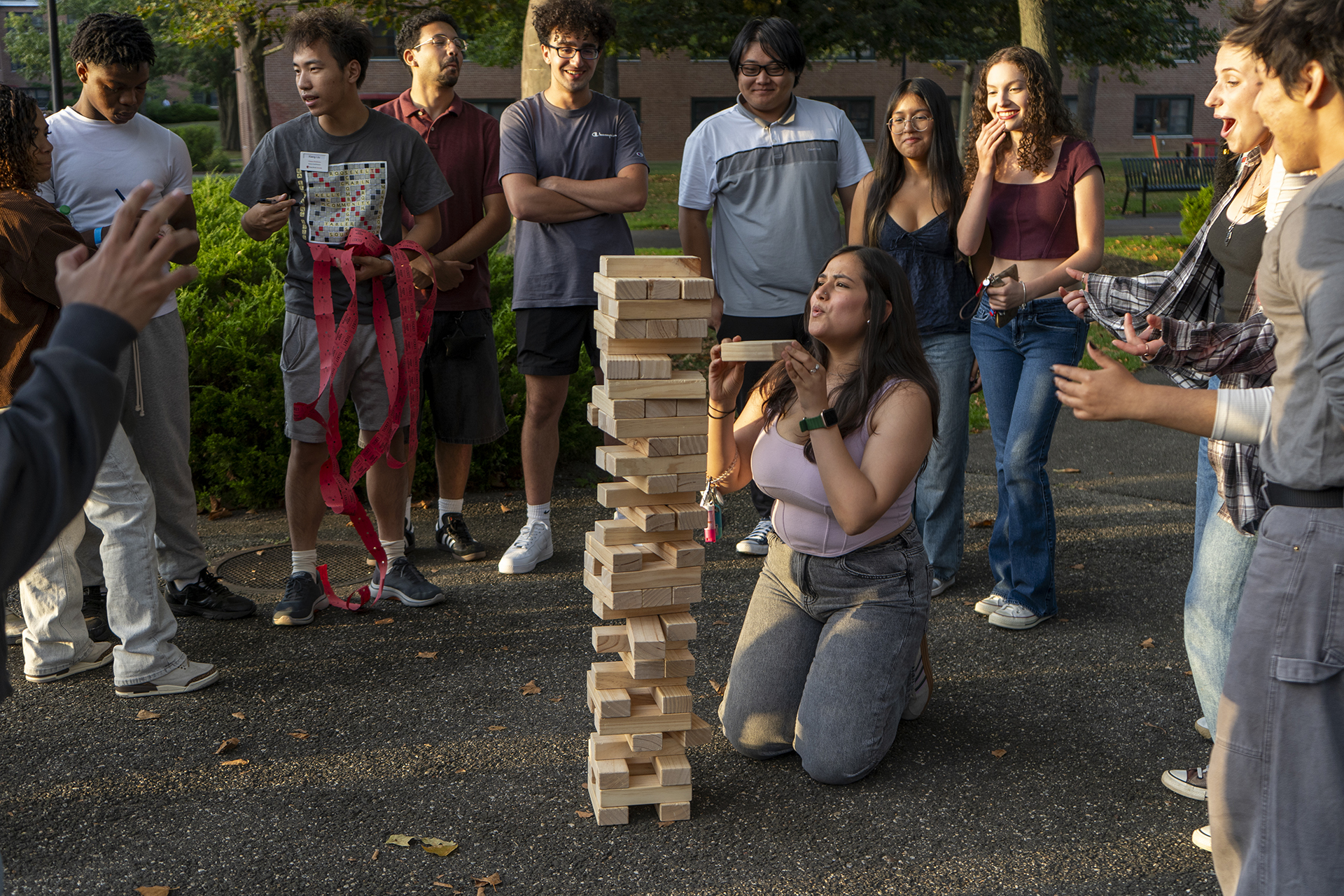 Students playing Jenga together with large blocks