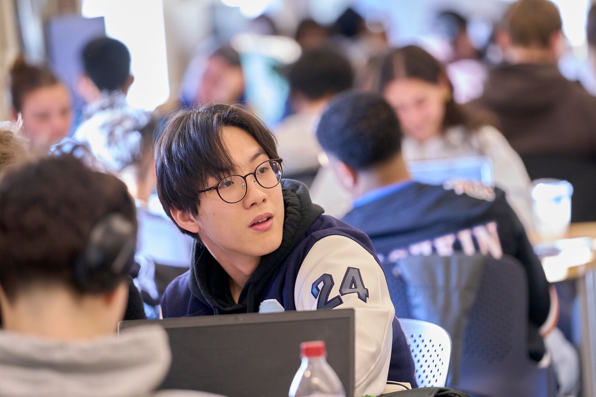 A student turning his head in a study hall.