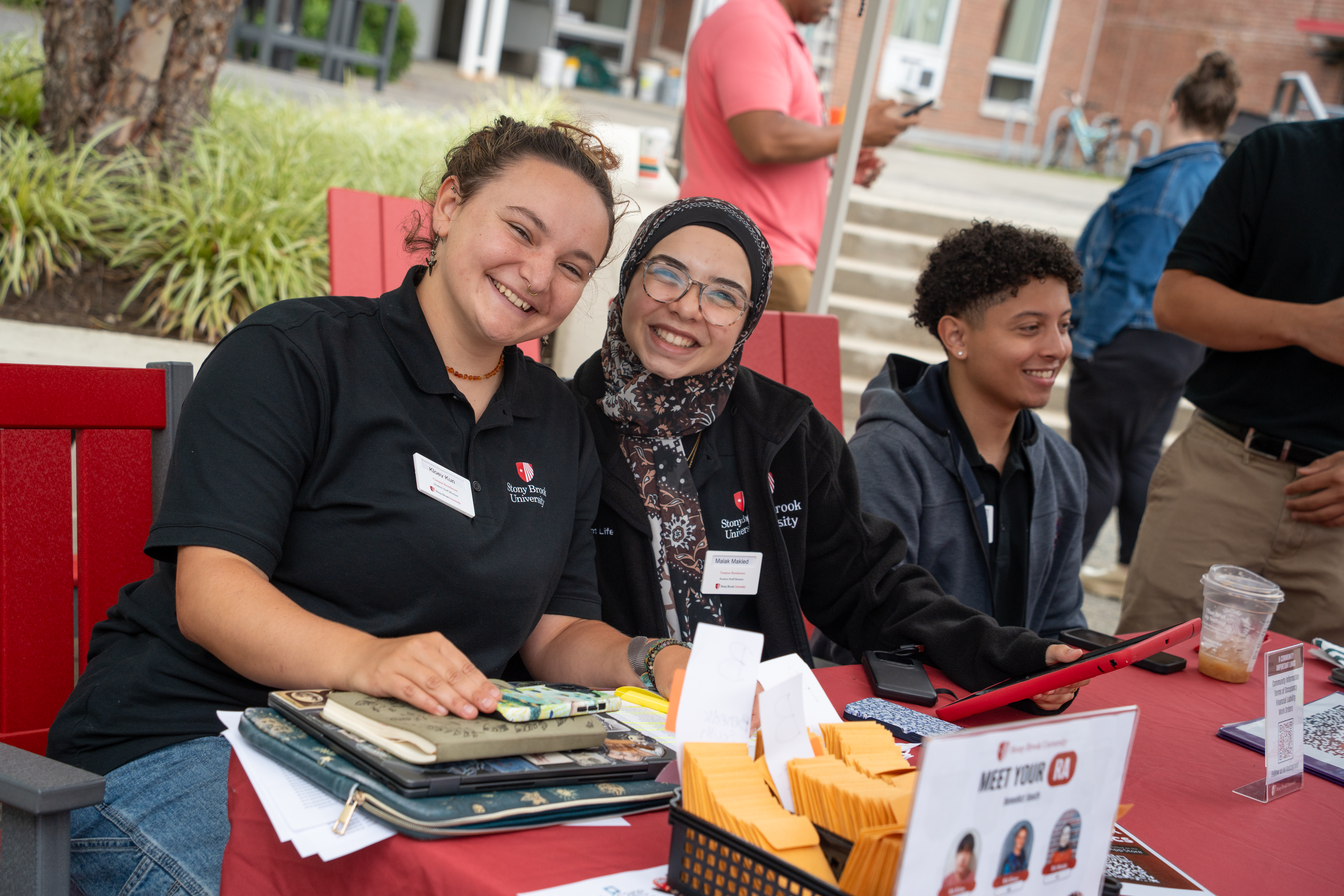 Resident Assistants sit at a check-in table