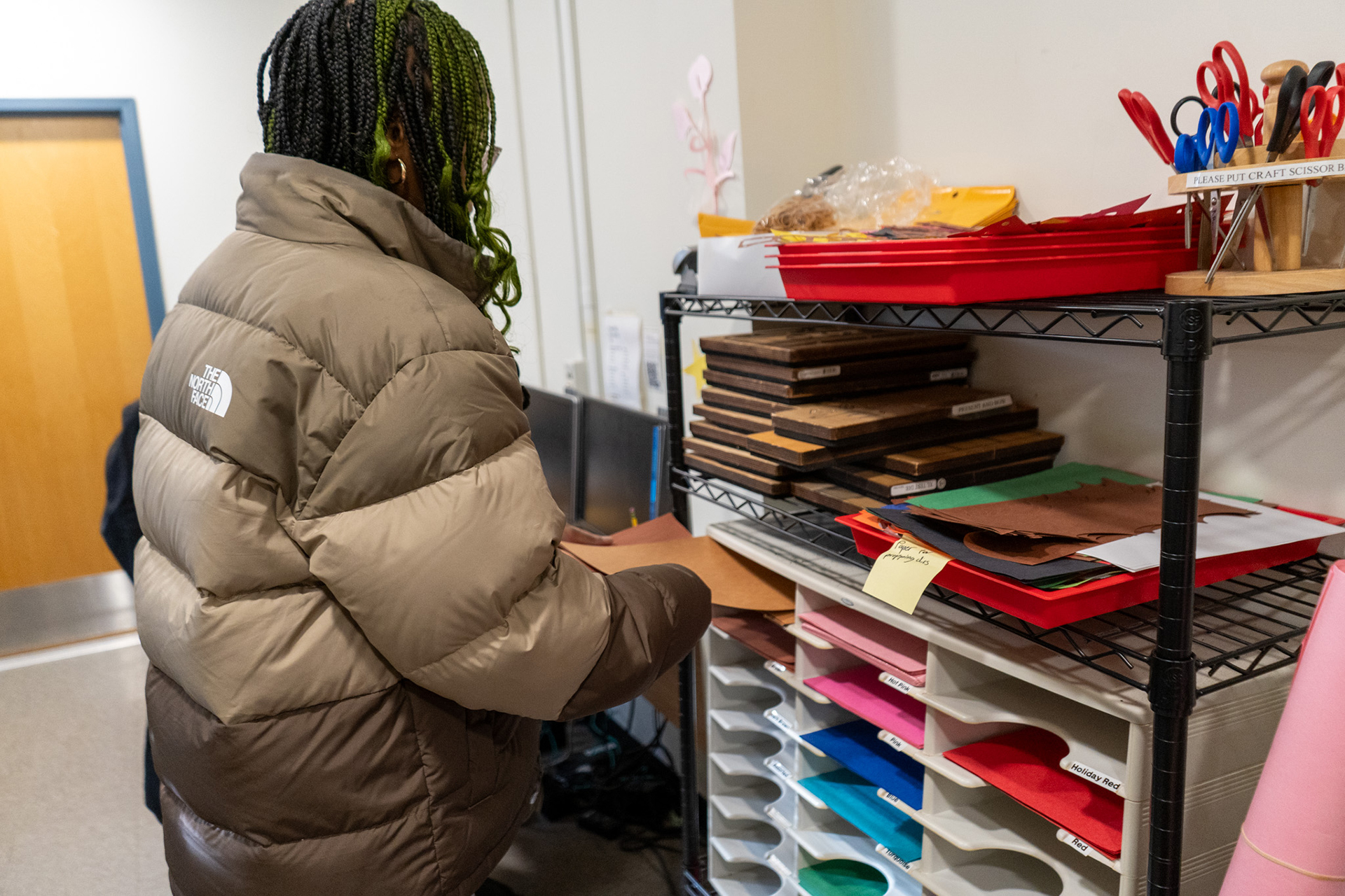 A resident assistant looking through construction paper.