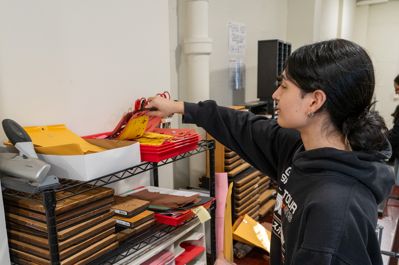A student looking through stencils.