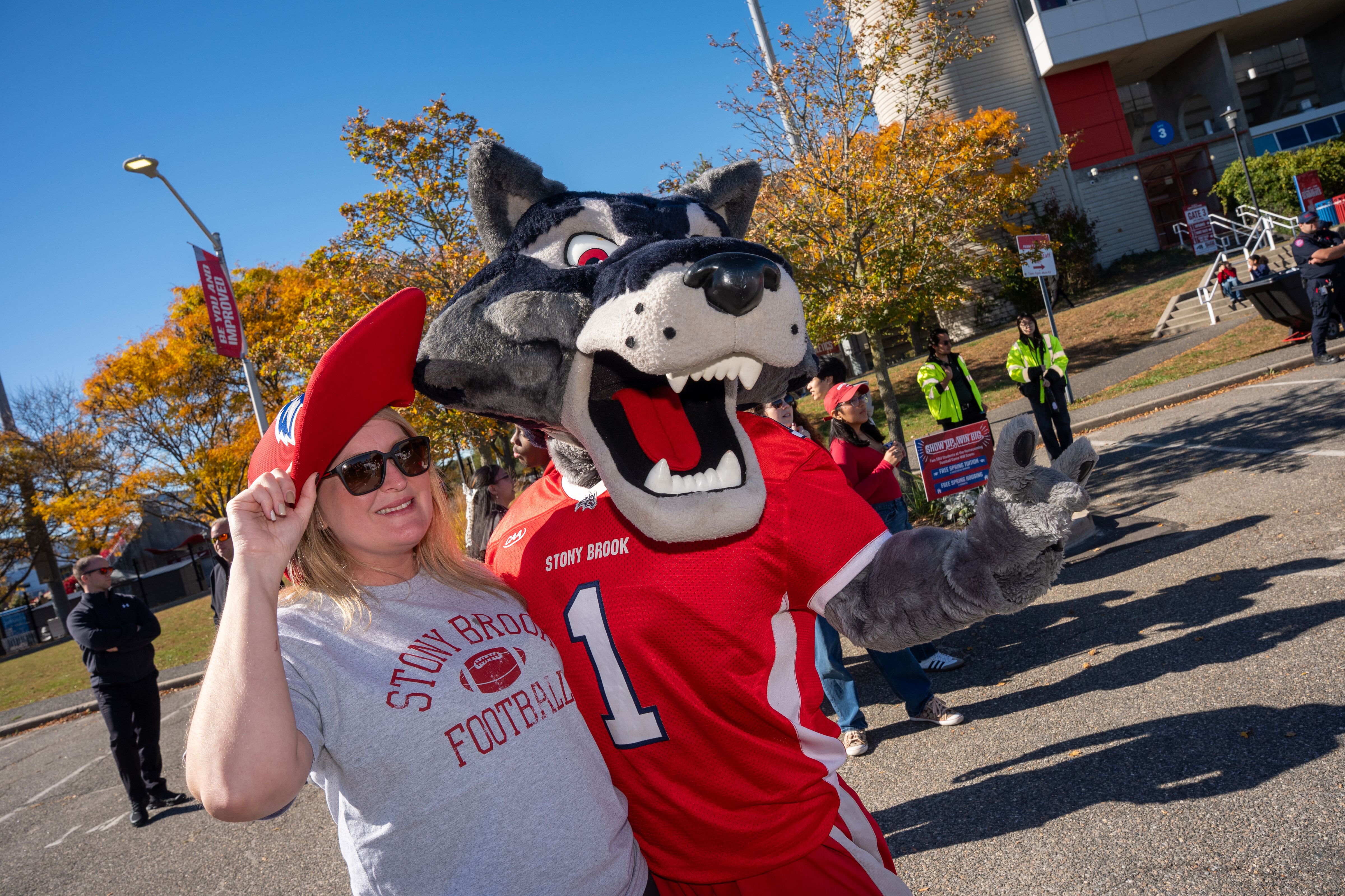 Wolfie stands next to a student who is wearing Wolfie's hat