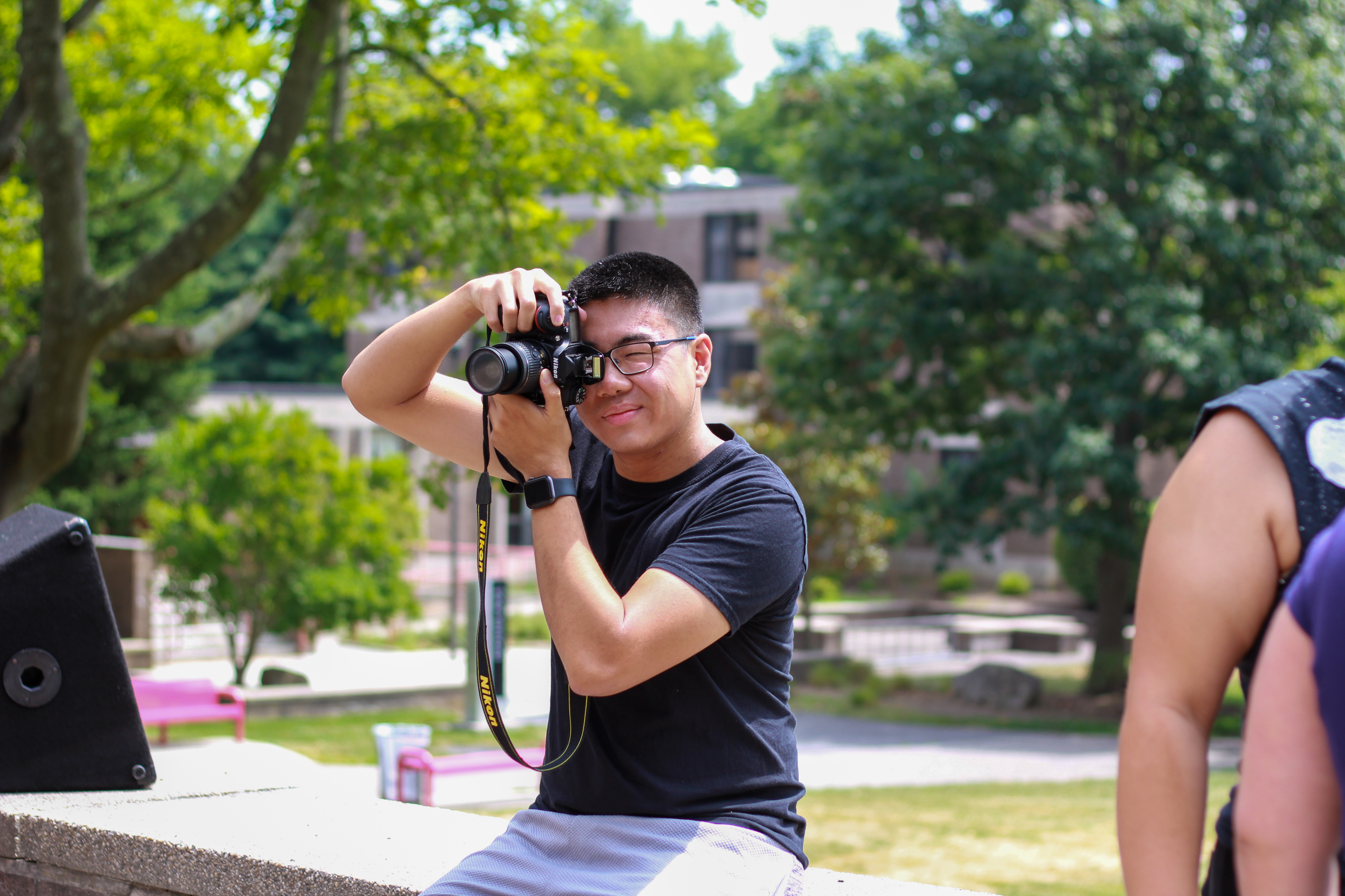 Student holds a camera to take a photo