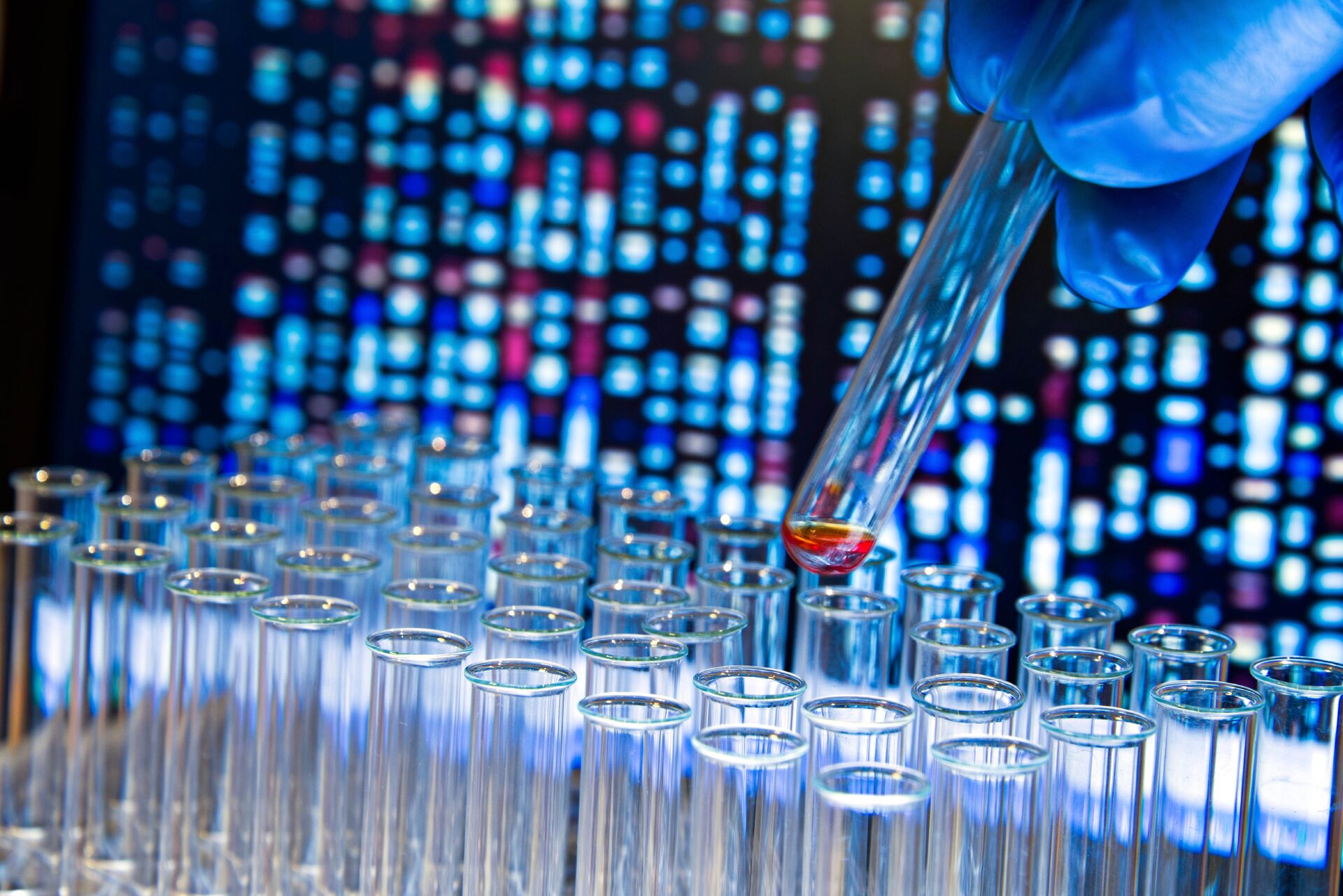 A researcher is handling a test tube containing a liquid sample.