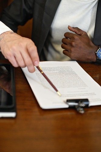 People Signing grant application