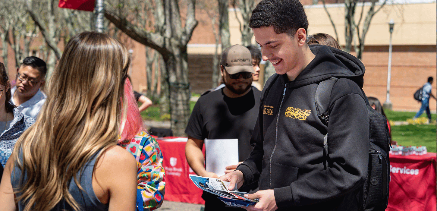 Student and Staff interacting at fair