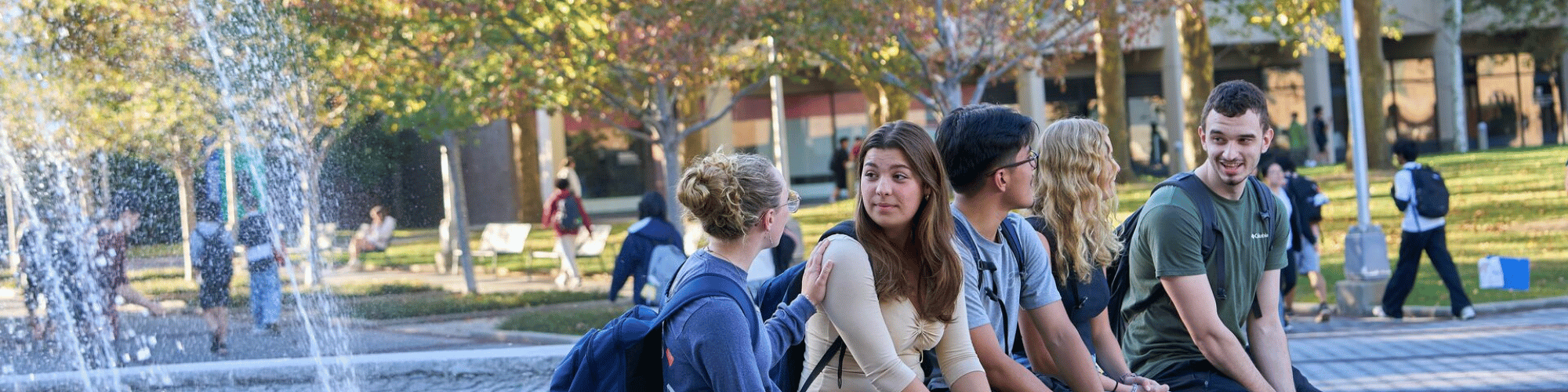 Students talking at water fountain