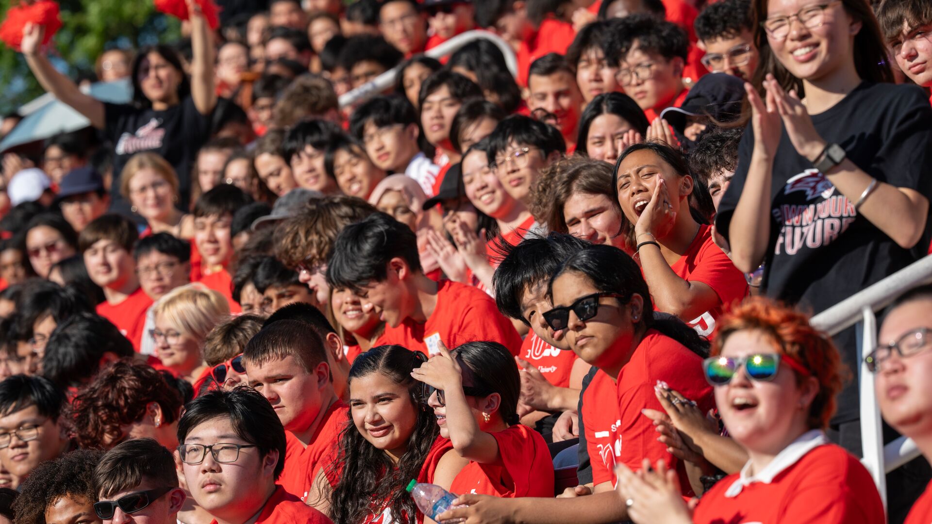 Students in the grandstands cheering at new student convocation