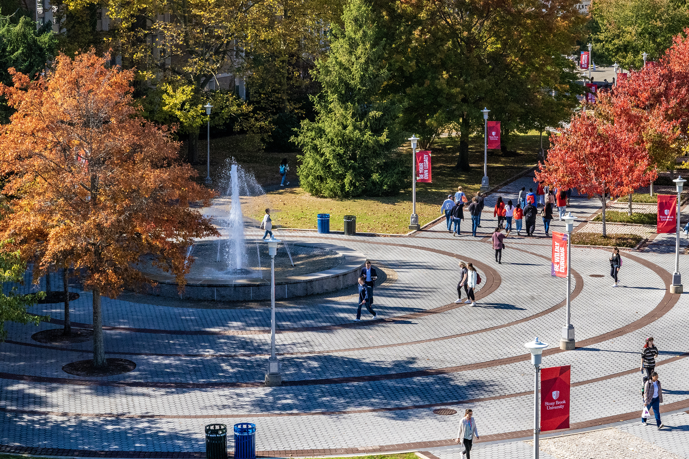 Many students walking on Stony Brook University campus.