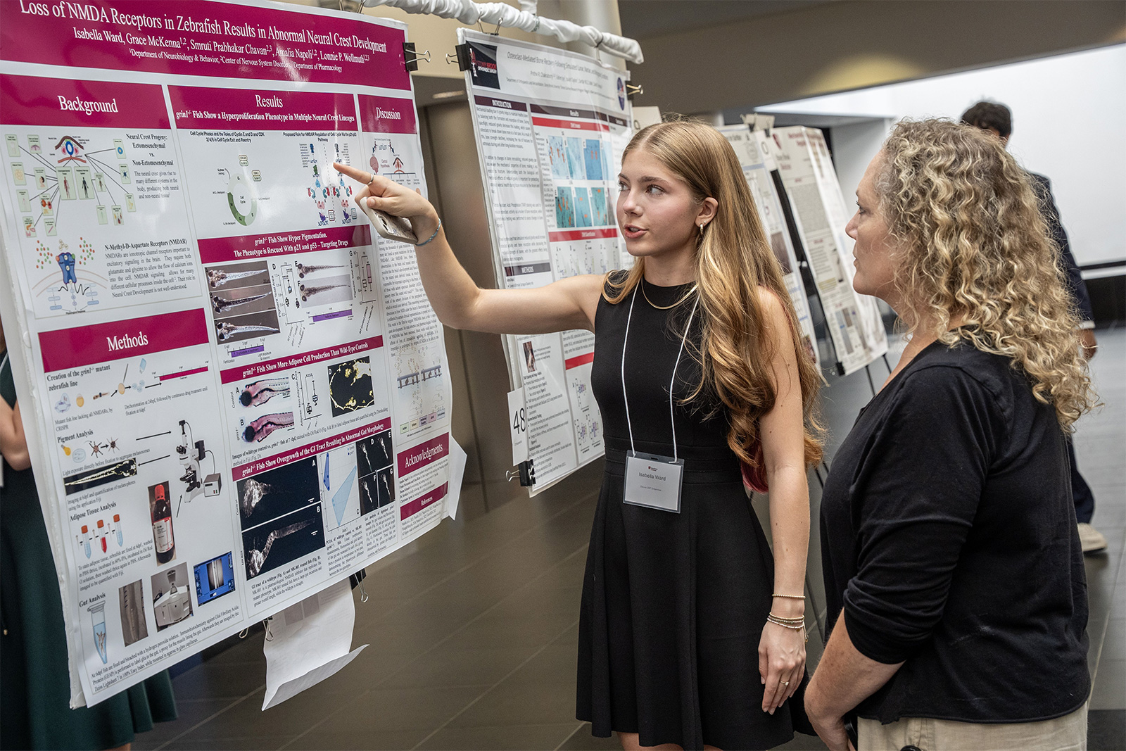 SSRP Fellow presents her research poster to a mentor