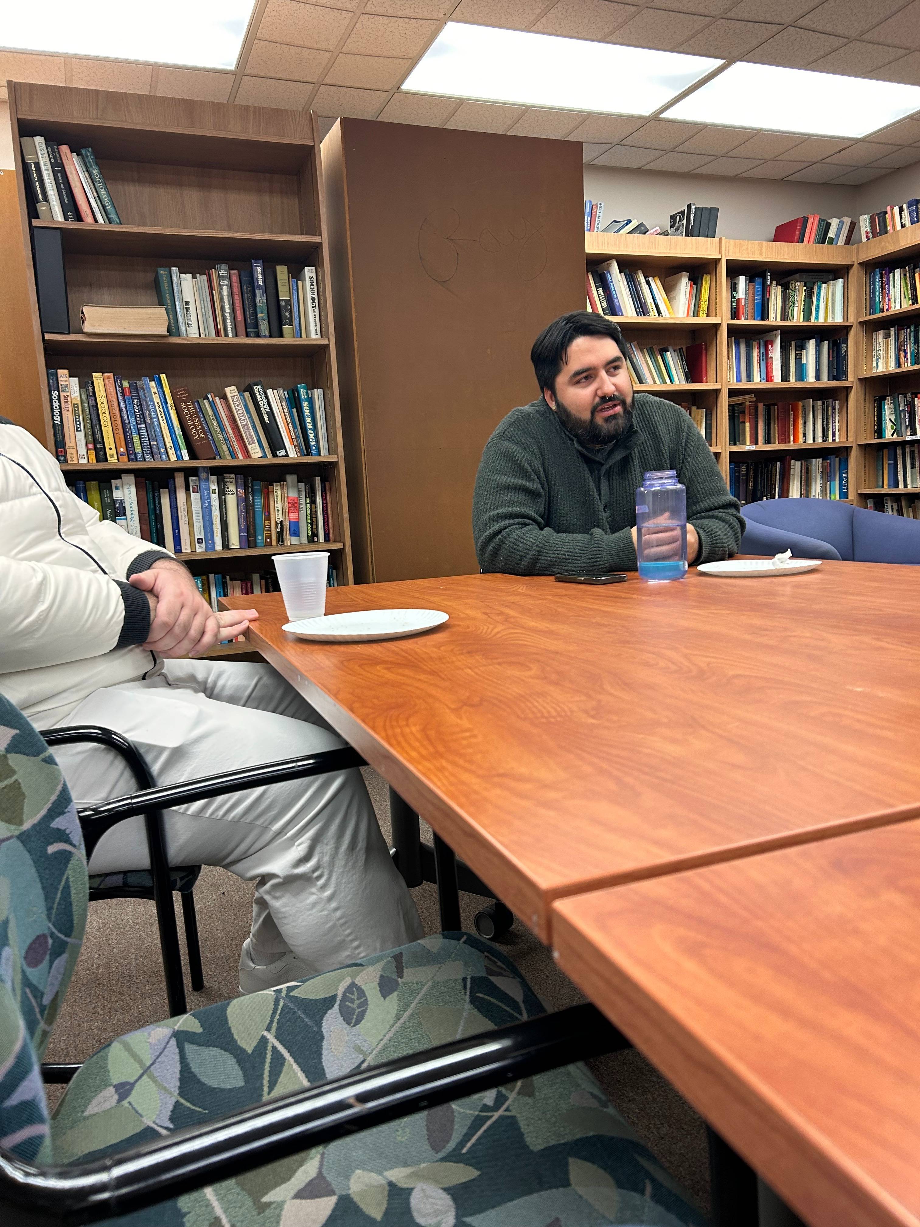 Professor speaking to students in a library