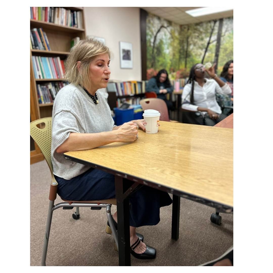 Professor speaking to students in a library