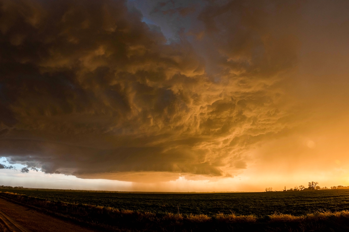 A storm cloud floats in the sky over the horizon