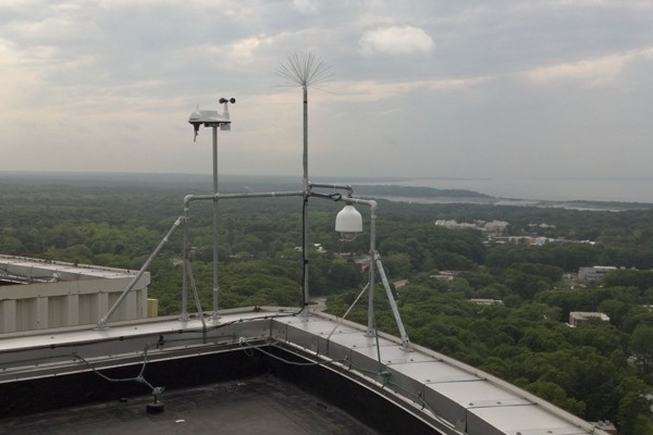 The weather station and camera on the roof of the Health Sciences Center overlooking Stony Brook University