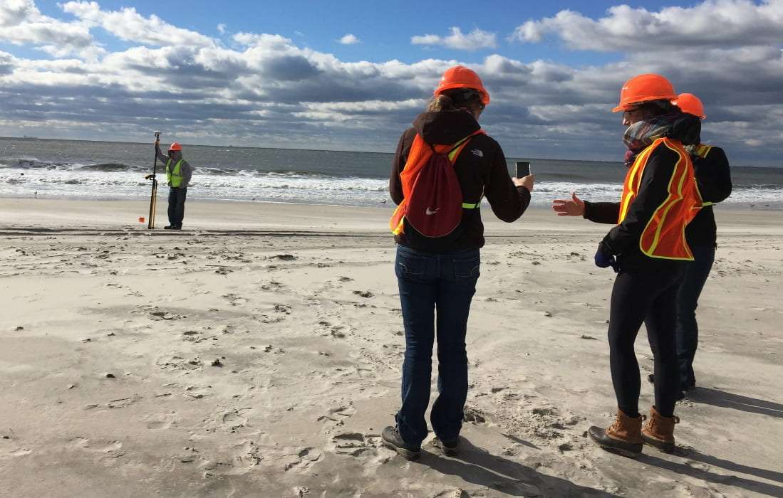 Students conduct a beach profile measurement for their GIS course