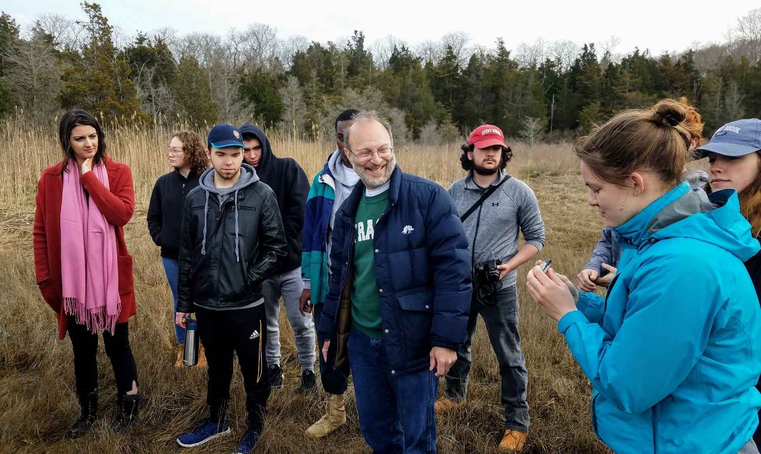 A group of students explore the Flax Pond marsh with the naturalist from the lab