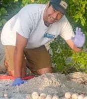 Andrew Glinsky waves while working at the beach