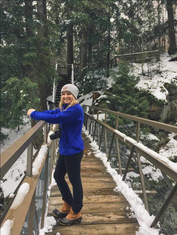 Liz Ahearn stands on a bridge overlooking a snowy mountain Liz Ahearn stands on a bridge overlooking a snowy mountain