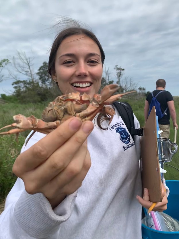 Ellie Evans holds a crab for the camera