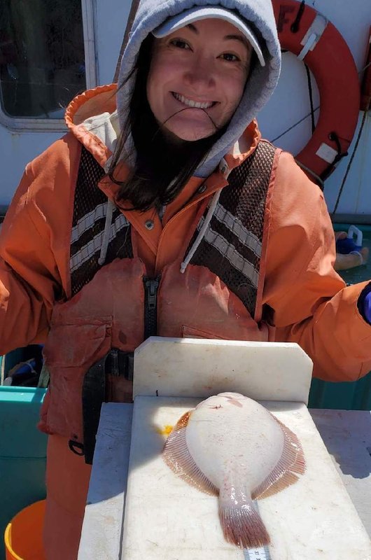 Jordan Russo works with a fluke onboard a research vessel Jordan Russo works with a fluke onboard a research vessel