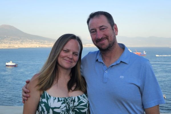 Michele and Frank Fischer stand with a large body of water behind them
