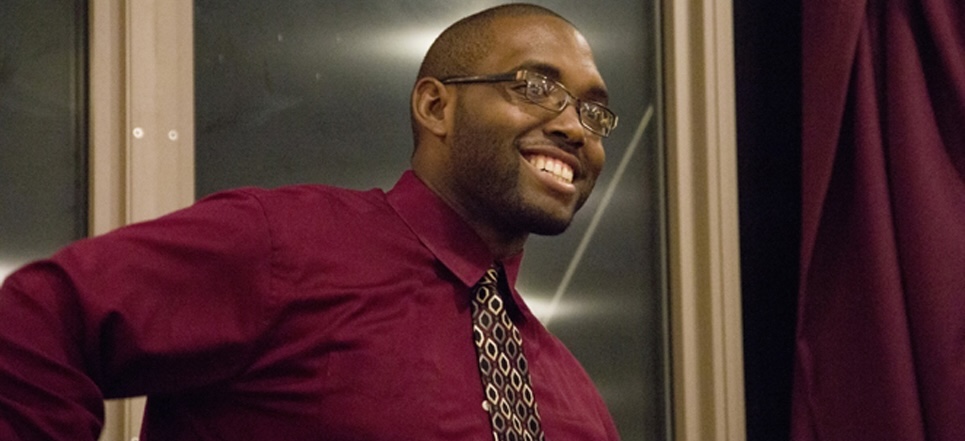 An English MAT student smiling in a dress shirt