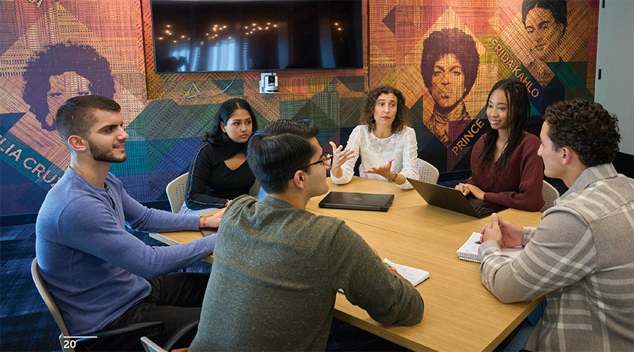SBU students have a discussion around a table in the Uniti Center on campus