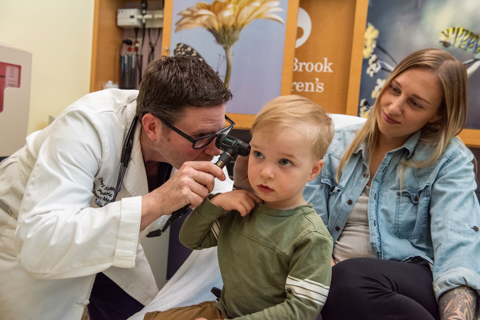 Doctor looking into a child's ear